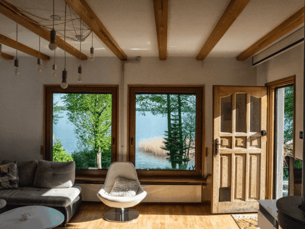 living-room-with-couch-chair-window-with-view-lake (1)